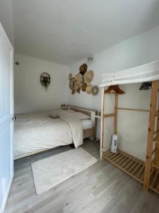 a bedroom with two bunk beds and a ladder at Appartement cocooning in Saorge