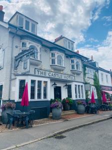 a white building with a cafe in front of it at Castle Hotel in Eynsford