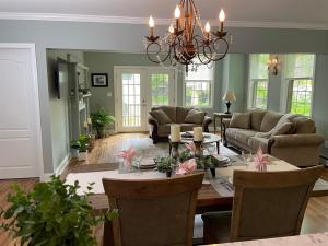 a living room with a table and a dining room at The Millhouse Downtown Chester in Chester