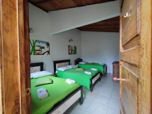 a room with three beds in a room at Hotel Monte verde in Salento