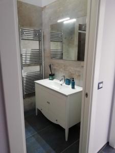 a bathroom with a white sink and a mirror at Domus Mea in Nardò