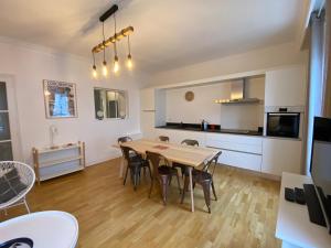 a kitchen and dining room with a table and chairs at LA VILLE A LA MER N°1 in Concarneau