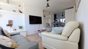 a living room with a couch and a chair at Modern 2-bedroom flat near Chelsea in London