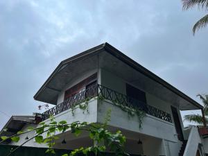 a building with a balcony on top of it at Crystal Lake Resort in Kandy