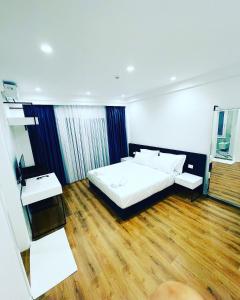 a bedroom with a bed and a wooden floor at SEA & LAKE VIEW VILLA in (( Kalive Gjoka ))