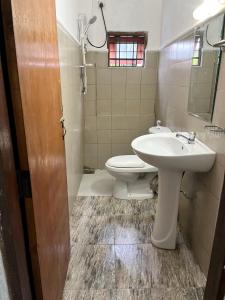 a bathroom with a sink and a toilet at Crystal Lake Resort in Kandy