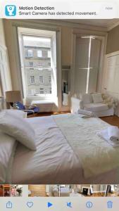 a picture of a bedroom with a bed and a window at Beautiful Georgian New Town Flat in Edinburgh