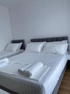 a bed with two towels and two pillows on it at SEA & LAKE VIEW VILLA in (( Kalive Gjoka ))