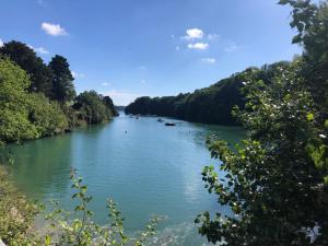 a river with trees on both sides of it at LA MABONNAIS in Pleurtuit