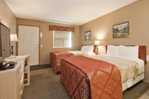 A bed or beds in a room at Bow River Inn