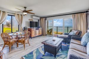 a living room with a couch and a table at Pono Kai Resort in Kapaa