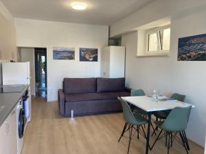 a living room with a couch and a table and chairs at Bellevue 1 in Izola +5 photos