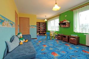 a childs room with a blue couch and green walls at Pokoje u Gruszki in Swarzewo