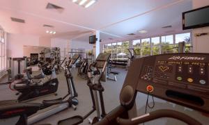 a gym with several treadmills and cardio machines at Dreams Tulum Resort & Spa in Tulum