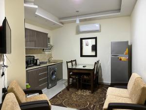 a living room with a kitchen and a table with chairs at Casablanca Beach Hurgada in Hurghada