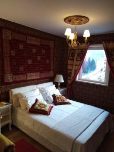 a bedroom with a large bed with two pillows on it at Red Lux in Budva