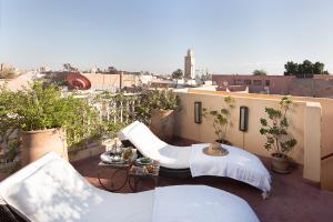 an apartment balcony with a view of a city at Riad Cocoon in Marrakesh