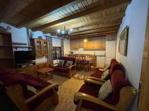 a living room with couches and a dining room at La Serrota Casa Rural in Navacepedilla de Corneja