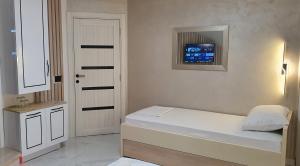 A bed or beds in a room at Pansion Eden