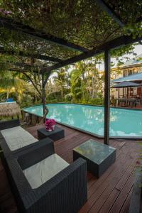 a patio with chairs and a swimming pool at The Samoan Outrigger Hotel in Apia