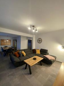a living room with a couch and a table at Ferienhaus International in Bad Harzburg