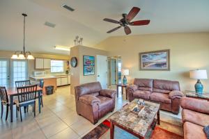 a living room with couches and a ceiling fan at Cozy Sebring Condo with Screened Porch and Grill! in Sebring