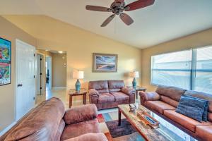 a living room with two couches and a ceiling fan at Cozy Sebring Condo with Screened Porch and Grill! in Sebring