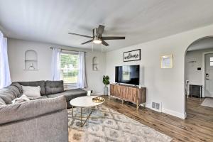 a living room with a couch and a flat screen tv at Orchard Park Home Less Than 2 Mi to Highmark Stadium! in Orchard Park