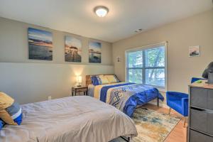a bedroom with two beds and a window at Lakefront Eatonton Getaway with Dock and Grill! in Resseaus Crossroads