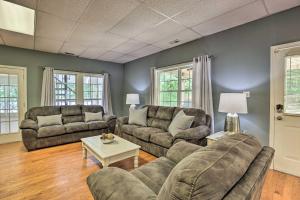 a living room with two couches and a table at The B Haus Lakefront Retreat with Boat Ramp! in Pell City