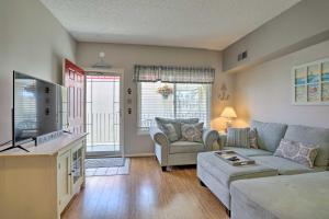 a living room with a couch and a tv at Quaint Wildwood Condo about Walk to Beach! in Wildwood