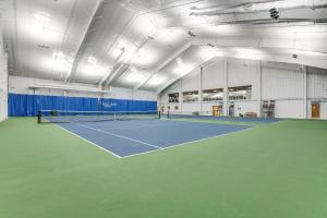 a tennis court in a building with a tennis racket at Sea Colony Round Robin VII in Bethany Beach