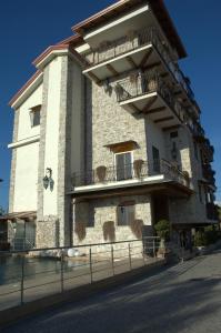 a large building with balconies on the side of it at Hotel Villa Clementina in Scafati