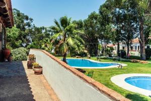 a swimming pool in a yard next to a house at Hotel Rural Terrablanca in Villablanca