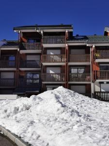 una pila de nieve frente a un edificio en Studio les fleury, en Mieussy