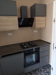 a kitchen with a stove and a counter top at La Casa di Noemi in Savona