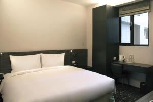 Postel nebo postele na pokoji v ubytování Capital Hotel SongShan