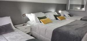 a bedroom with two beds with yellow pillows at CORAZOn BUENOs AIREs PLATINo in Buenos Aires