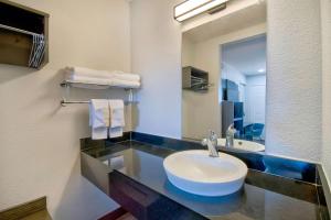 a bathroom with a sink and a mirror at Motel 6-Vallejo, CA - Six Flags West in Vallejo