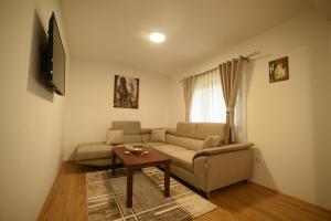 a living room with a couch and a table at VUKOVIC HOUSE-MOTICKI GAJ in Žabljak