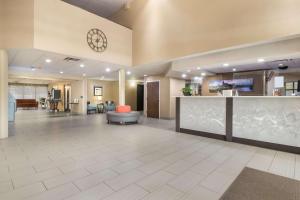 a lobby of a hospital with a clock on the wall at Best Western Suites near Opryland in Nashville