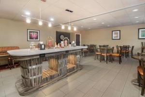 a bar in a restaurant with tables and chairs at Best Western Suites near Opryland in Nashville