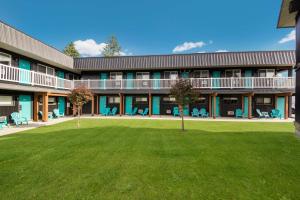 a building with a lawn in front of it at Stoke Hotel SureStay Collection by Best Western in Revelstoke
