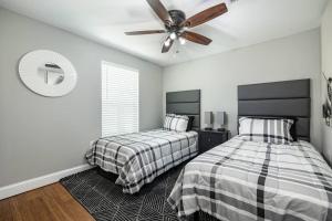 1 dormitorio con 2 camas y ventilador de techo en Grand Oaks Terminal in the Heights, en Tampa