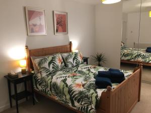 a bedroom with a bed with a couch and a table at Columba House in Inverness