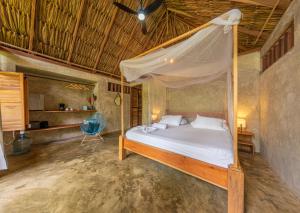 a bedroom with a bed and a canopy at Casa Chapolin Boutique in Palomino