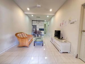 a living room with a couch and a table at Jiaxin Homestay - Puteri Wangsa 家馨民宿 in Ulu Tiram