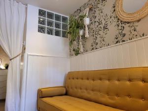 a living room with a couch and a curtain at "COZY LOFT", TERRACE, PARKING and SWIMMING POOL in Málaga