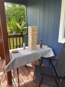 a table with a block tower on a patio at Cozy tiny home cabin in Eva, TN 