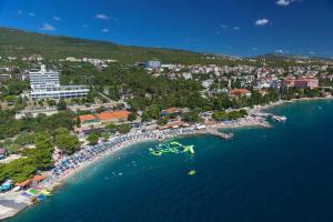 an aerial view of a beach with a crowd of people at Apartments by the sea Dramalj, Crikvenica - 5522 in Dramalj